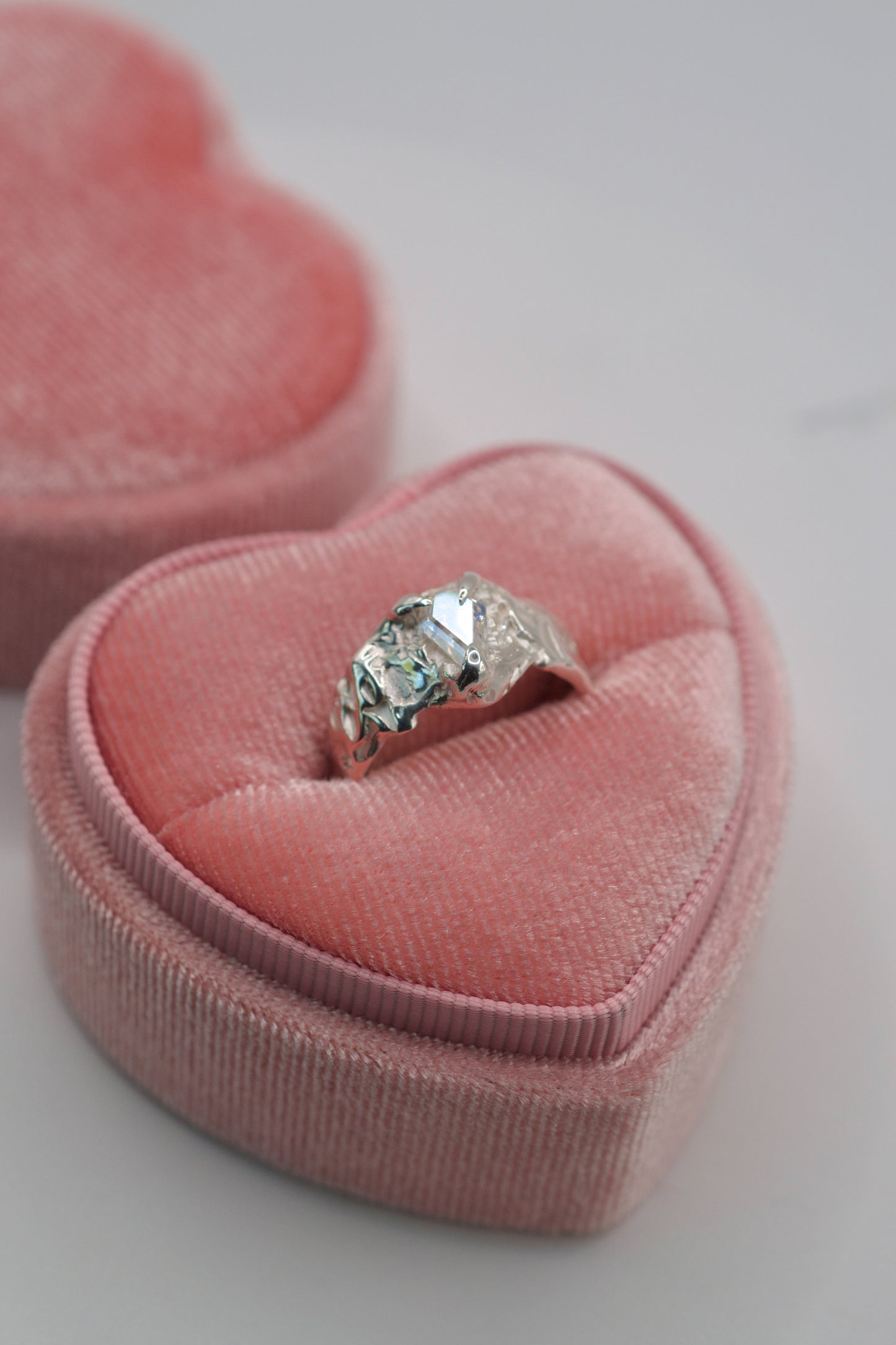 molten sterling silver ring with coffin shape moissanite in pink velvet heart box