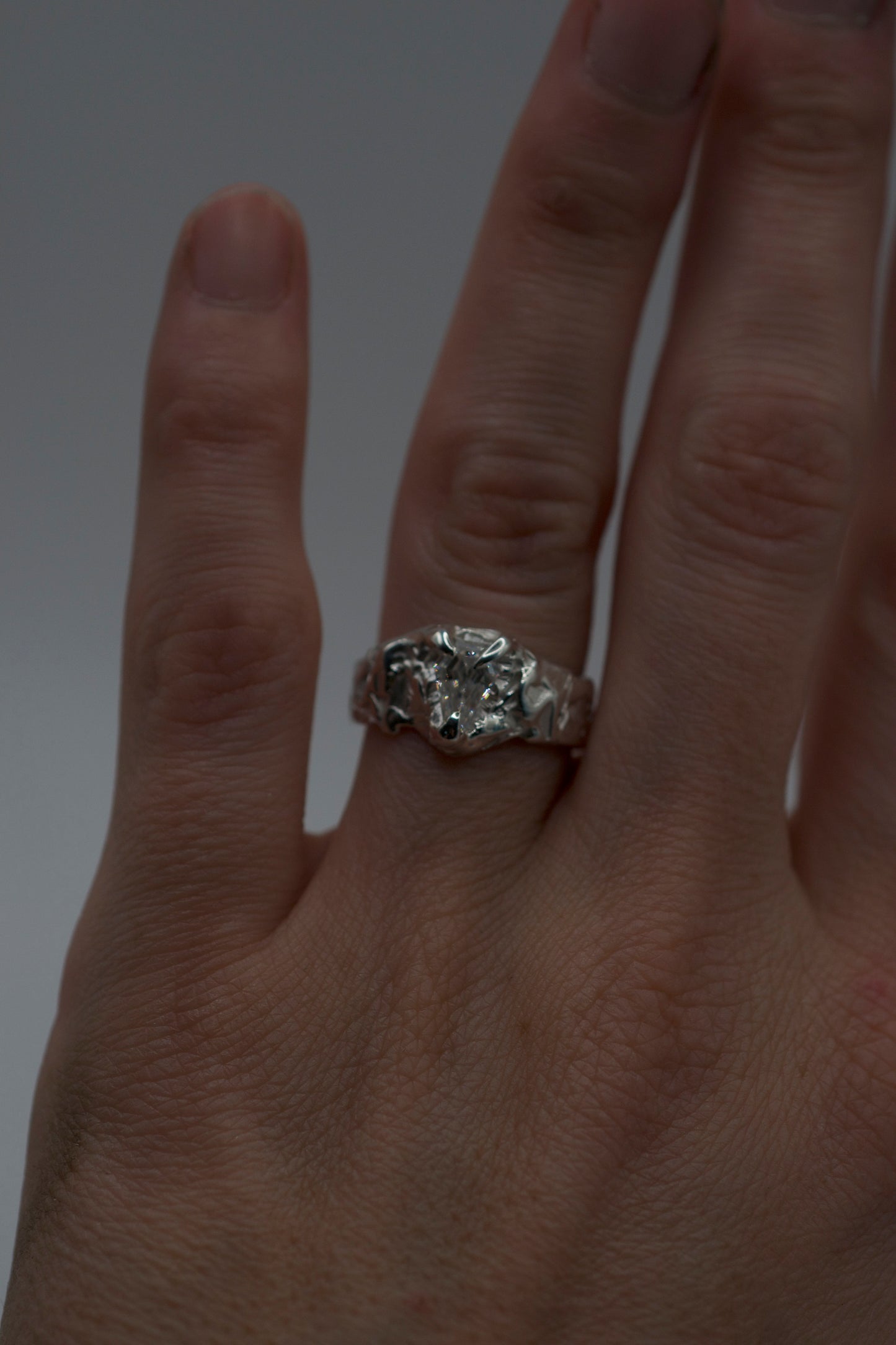 alternative engagement ring with coffin mosisanite stone on textured molten sterling silver band