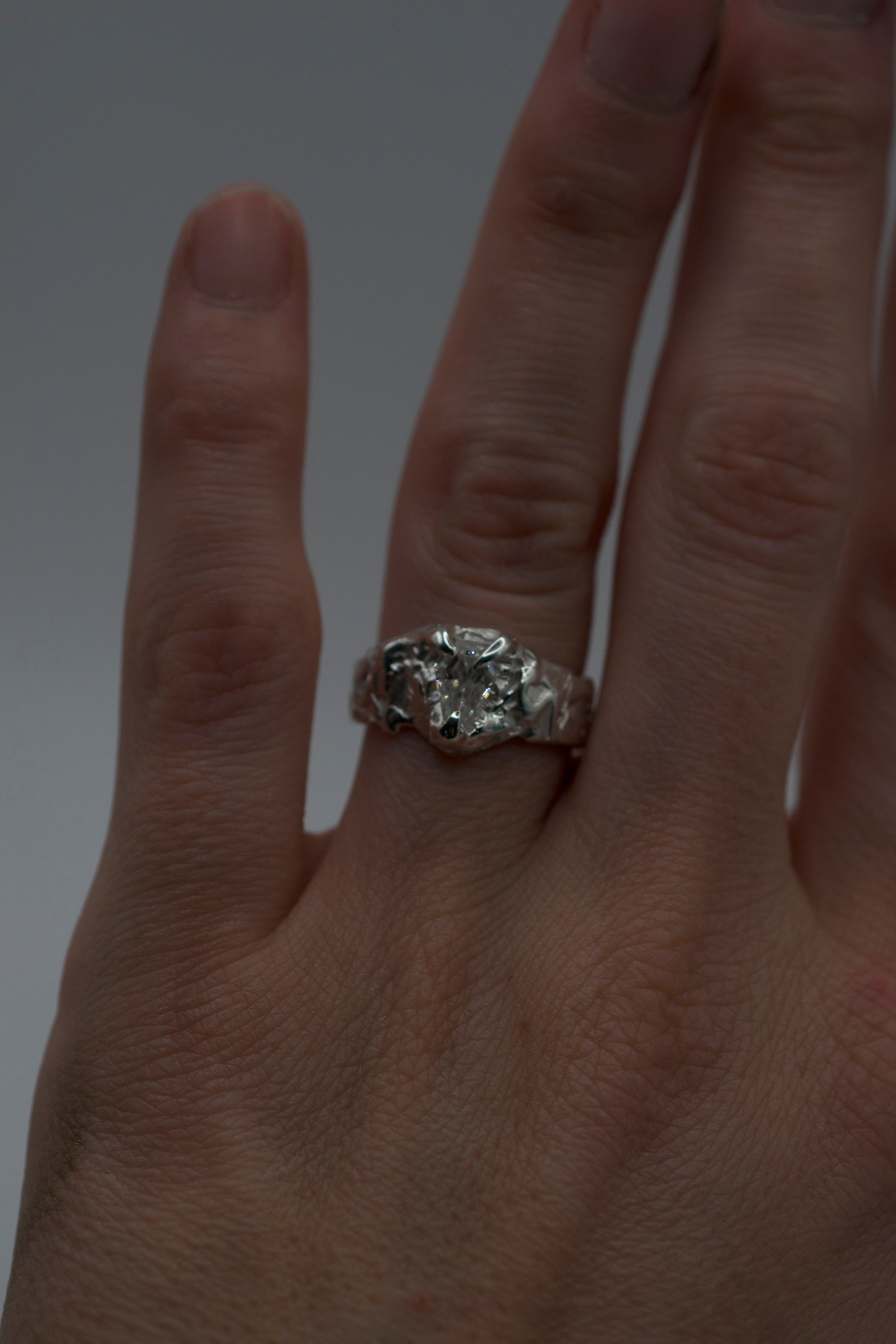 alternative engagement ring with coffin mosisanite stone on textured molten sterling silver band