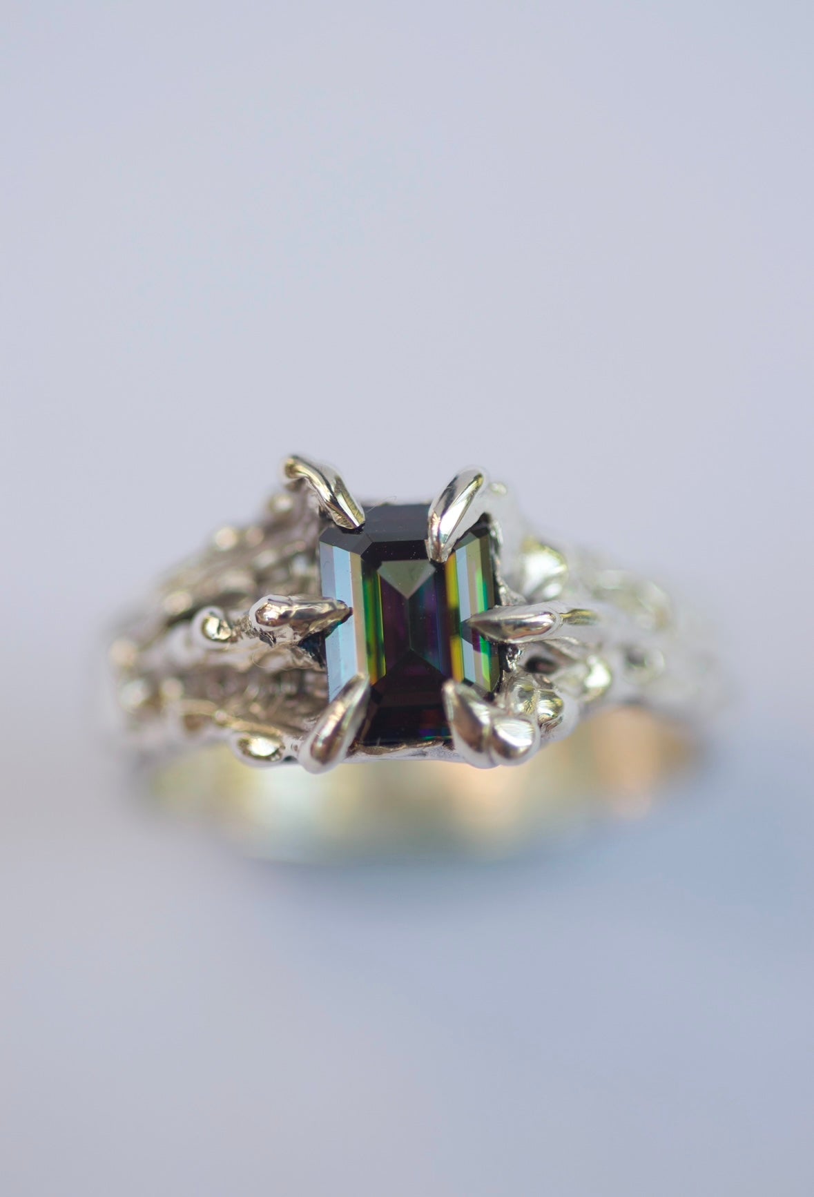 Lost wax cast silver Violet Ring with rainbow moissanite and sharp molten dragon claws worn on hand alternative jewellery